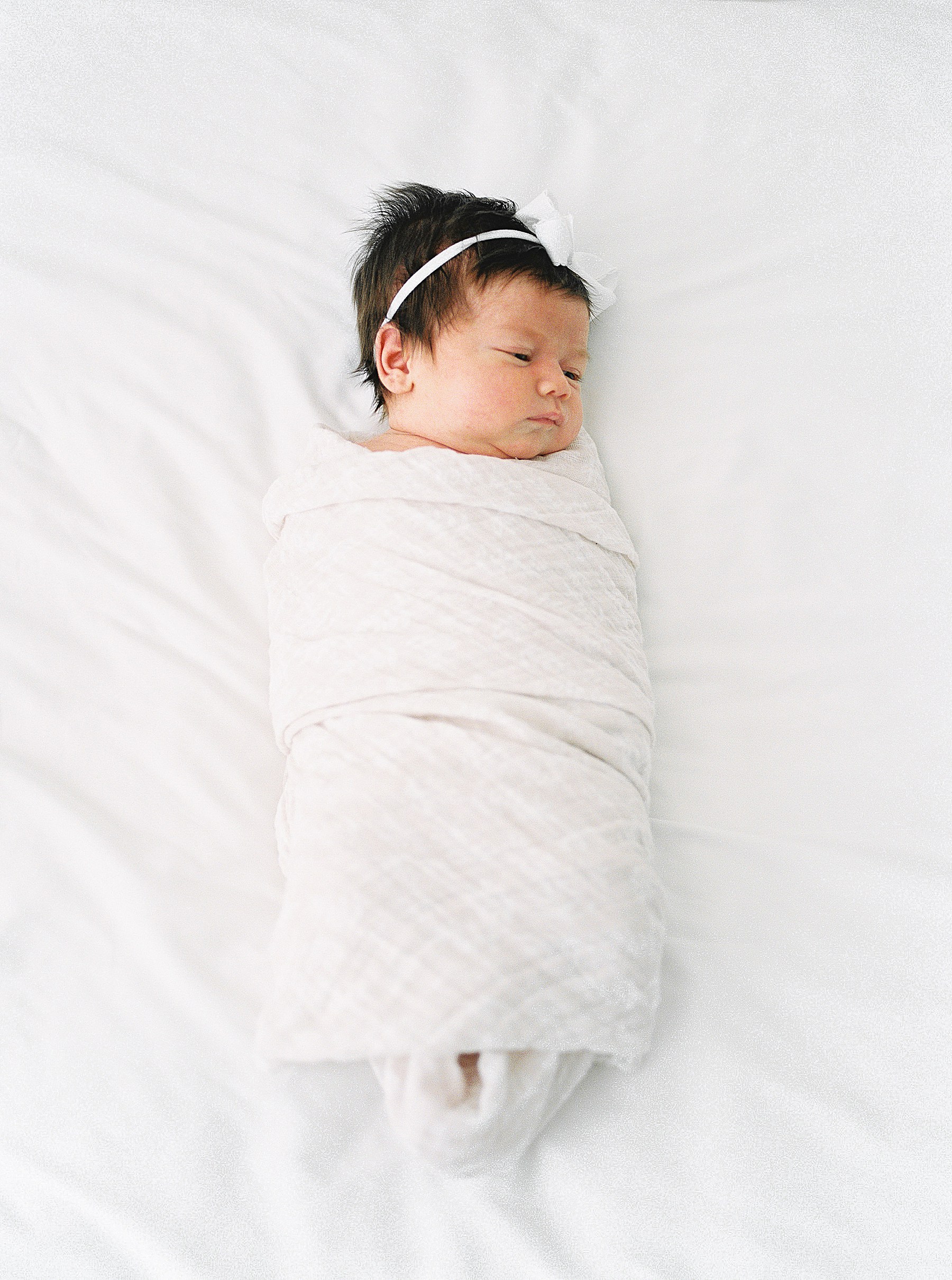 Little Rock Arkansas Newborn Session | baby girl swaddled with bow